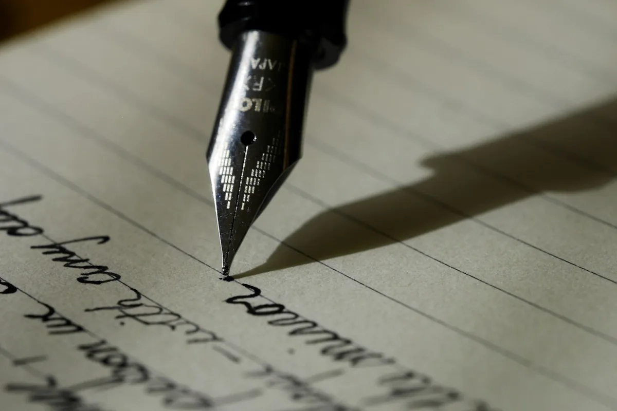 A fountain pen resting on legal paper during the drafting of a transaction.