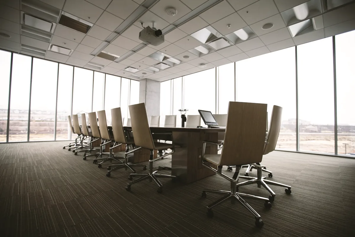 A boardroom prepared for a transaction meeting.